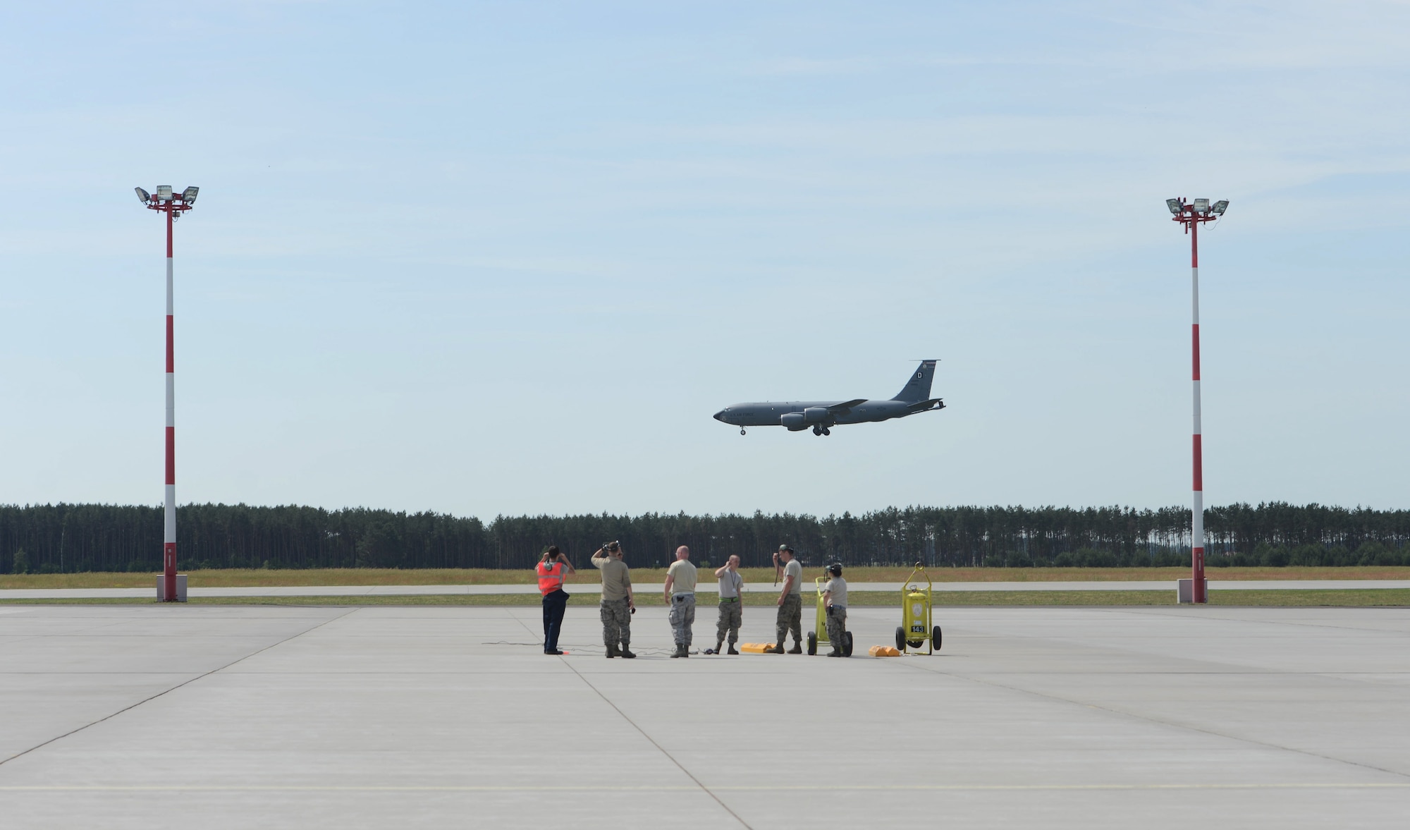 U.S. Air Force 351st Expeditionary Air Refueling Squadron-Poland maintainers watch a KC-135 Stratotanker land June 11, 2014, on Powidz Air Base, Poland, after the aircraft completed a Baltic Operations Exercise mission. Ten maintainers are working in Poland to support BALTOPS and make sure the aircraft is safe and ready for every mission. (U.S. Air Force photo/Airman 1st Class Kyla Gifford/Released)