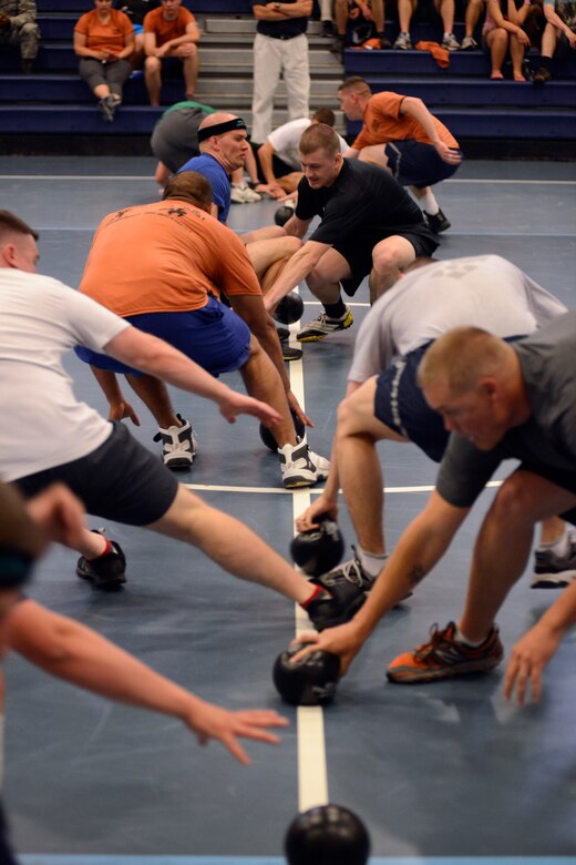 Participants race to the dodge balls during the Sexual Assault Prevention dodge ball tournament in the fitness center June 6, 2014, at Schriever Air Force Base, Colo. All participants received a t-shirt and headband. (U.S. Air Force photo/Christopher DeWitt)  