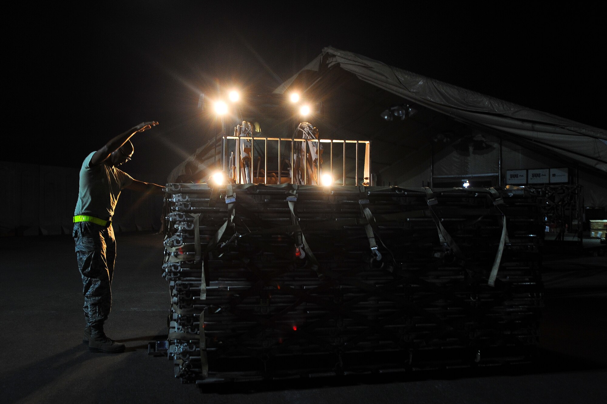 Staff Sgt. Ramon Corchado, 380th Expeditionary Logistics Readiness Squadron, directs a 10K all-terrain forklift into position June 11, 2014, at an undisclosed location in Southwest Asia.  The Airmen were weighing surplus pallets before shipping them to the main cargo-building hub for the AOR.  (U.S. Air Force photo by Tech. Sgt. Russ Scalf/Released)