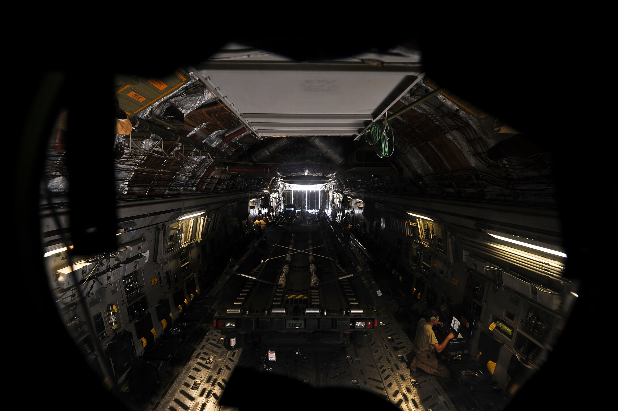 Airmen from the 380th Expeditionary Logistics Readiness Squadron Air Terminal Operations Center remove Tunner 60K cargo loader from a C-17 June 11, 2014, at an undisclosed location in Southwest Asia.  Almost all of the 380th Air Expeditionary Wing’s personnel and equipment pass through ATOC. (U.S. Air Force photo by Tech. Sgt. Russ Scalf/Released)