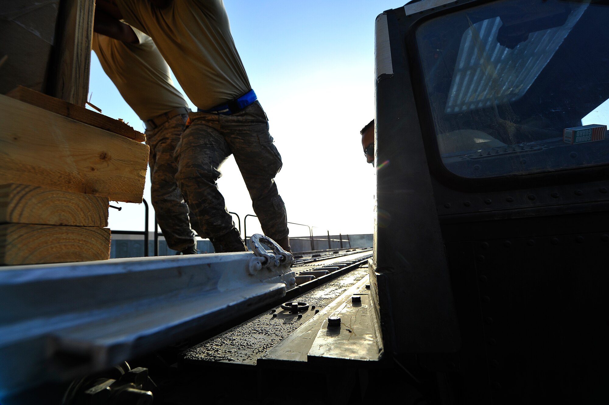 Airmen from the 380th Expeditionary Logistics Readiness Squadron Air Terminal Operations Center transfer cargo pallets from a 60K loader to the highline dock for temporary storage June 9, 2014, at an undisclosed location in Southwest Asia. The cargo is placed on the dock pending user pick-up. (U.S. Air Force photo by Tech. Sgt. Russ Scalf/Released)