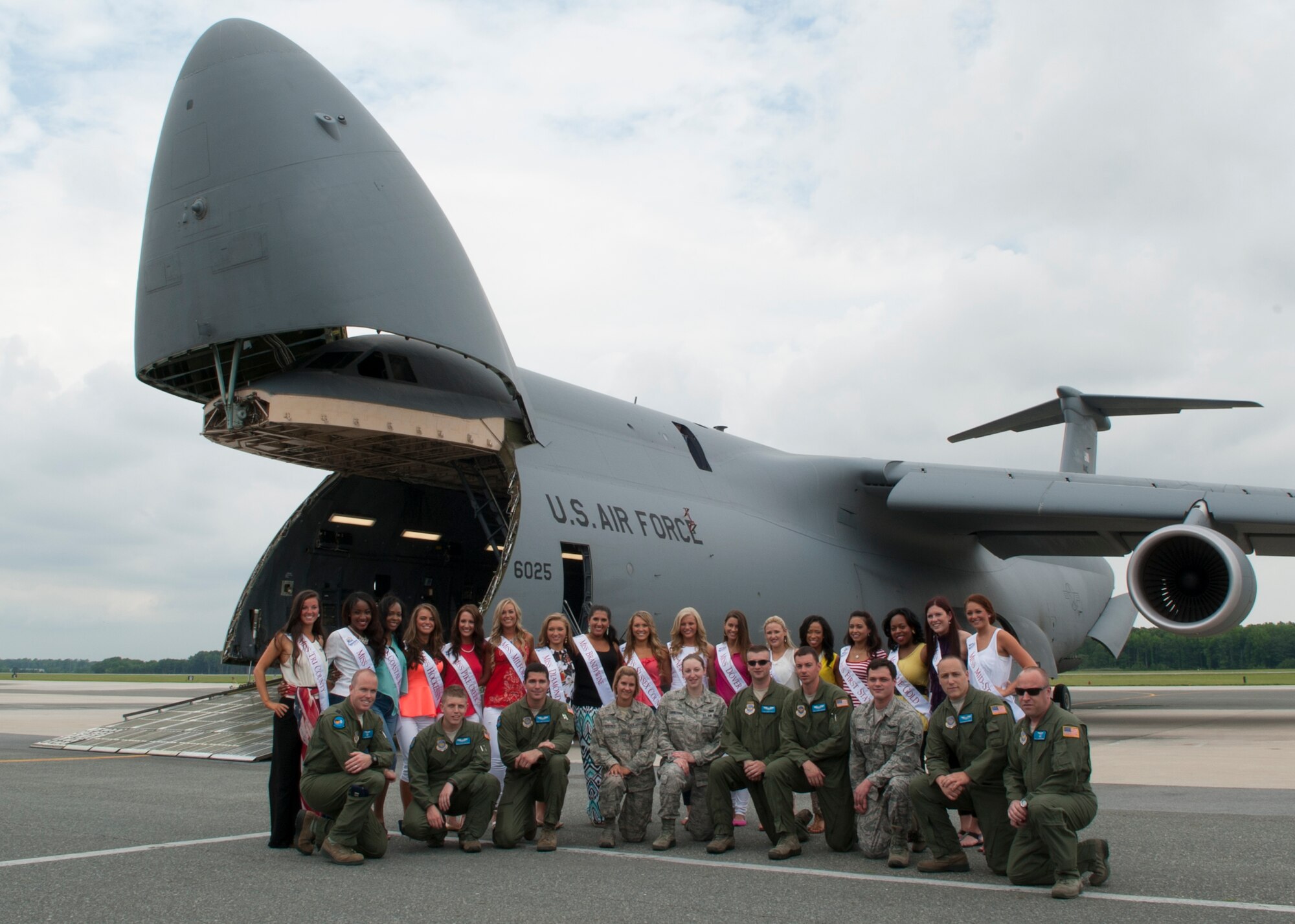 Miss Delaware contestants and Team Dover Airmen pose for a photo in front of a C-5M Super Galaxy June 10, 2014, at Dover Air Force Base, Del. The contestants received an in-depth tour of the aircraft and learned about its capabilities. (U.S. Air Force photo/Airman 1st Class Zachary Cacicia)