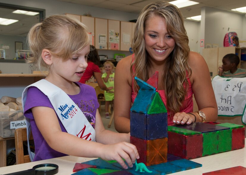 Amanda Crockett, Miss Sussex County, plays with a child during a Miss Delaware contestant tour June 10, 2014, at the Child Development Center on Dover Air Force Base, Del. The 2014 Miss Delaware contest is held each year in Dover, Del. (U.S. Air Force photo/Airman 1st Class Zachary Cacicia)