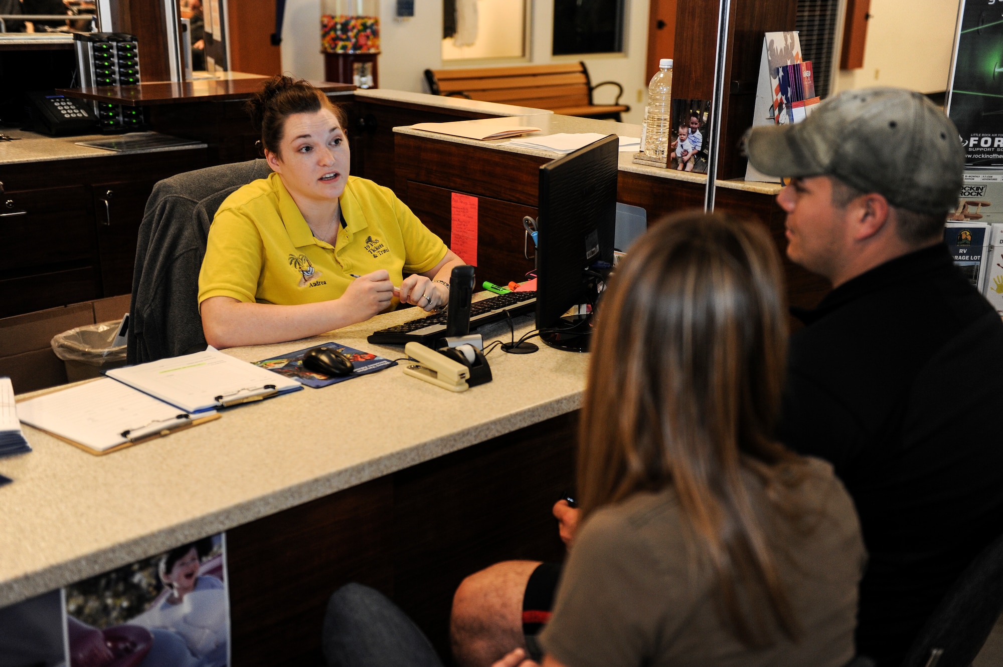 Andrea Hammock, the 19th Force Support Squadron Information, Tickets and Travel manager, discusses a vacation plan to Nashville with customers June 10, 2014, at Little Rock Air Force Base, Ark. The ITT center offers local travel as well as international and worldwide travel. (U.S. Air Force photo by Staff Sgt. Jessica Condit)