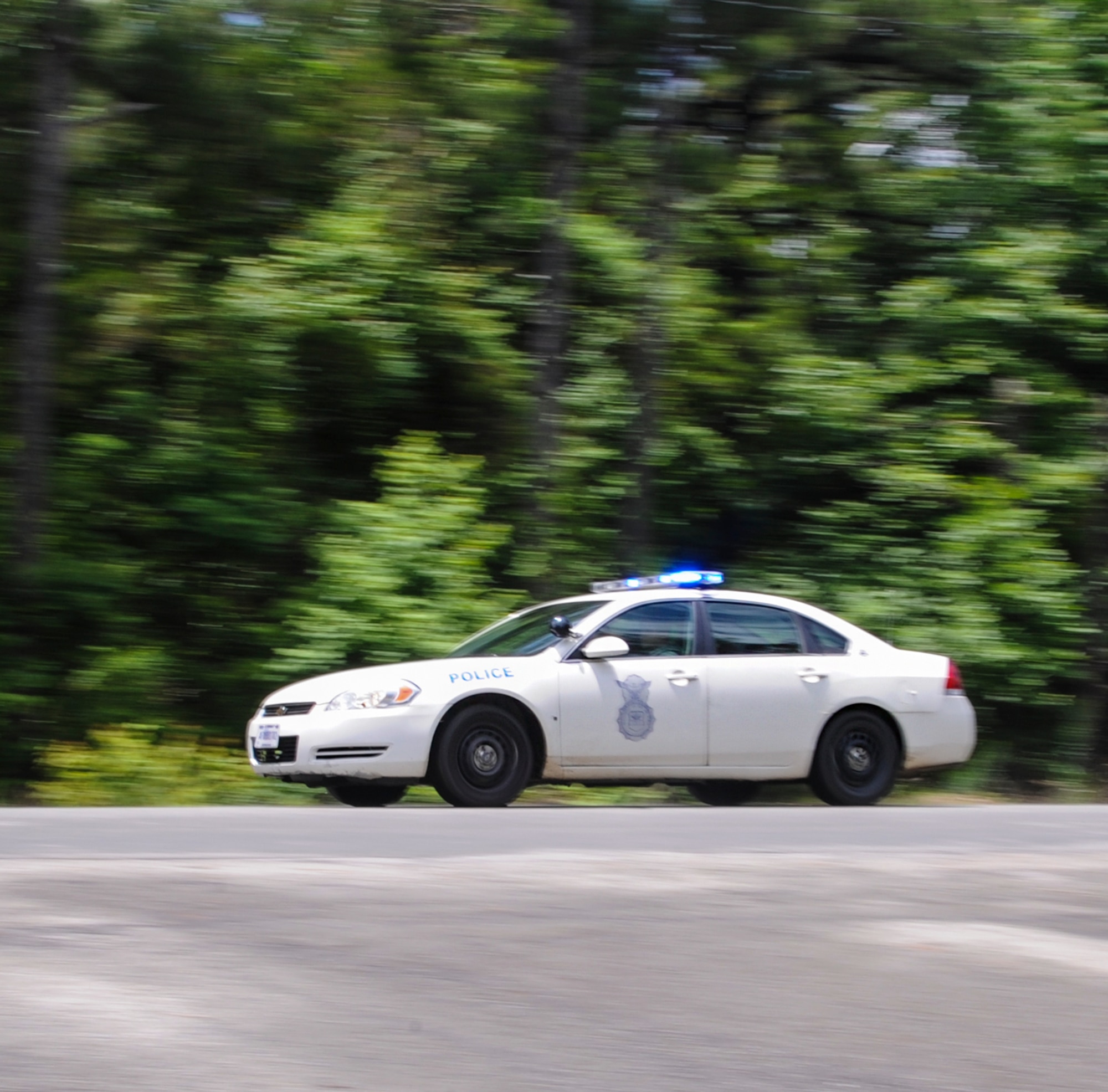 Two 19th Security Forces Squadron patrolmen respond to a call as part of a crisis response exercise June 10, 2014, at Little Rock Air Force Base, Ark. When in pursuit of a vehicle, 19th SFS Airmen still have jurisdiction despite being outside of the base gates. (U.S. Air force photo by Airman 1st Class Harry Brexel)