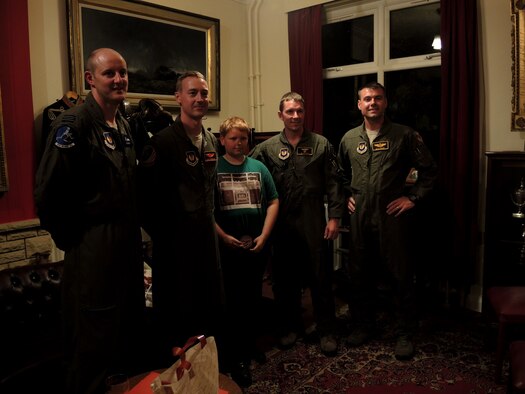 Royal Air Force Flight Lieutenant Ian Hart, U.S. Air Force Captains Chris Robinson and Jonathan Roe, and U.S. Air Force Maj. Nathaniel Wilds posed for a group photo with a young member of the Cirencester Air Group during a group meeting June 9, 2014 in Swindon, England. The Airmen were guest speakers at the event, and spoke about their training and their experiences as Air Force pilots. Hart, Roe and Wilds are stationed at Whiteman Air Force Base, Missouri, and Robinson is stationed at Barksdale Air Force Base, Louisiana. (U.S. Air Force photo by Candy Knight/Released)