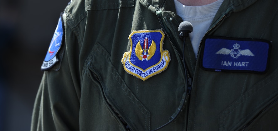 Royal Air Force Flight Lieutenant Ian Hart, GR4 Tornado pilot, wears a U.S. Air Forces in Europe patch on his flight suit to show he is part of the U.S. Air Force team, while participating in interoperability training RAF Fairford, England, June 10, 2014. Since 2012, he has been flying the B-2 as part of the 13th Bomb Squadron, Whiteman Air Force Base, Missouri. He has 11 years of aviation experience. (U.S. Air Force photo by Staff Sgt. Nick Wilson/Released)