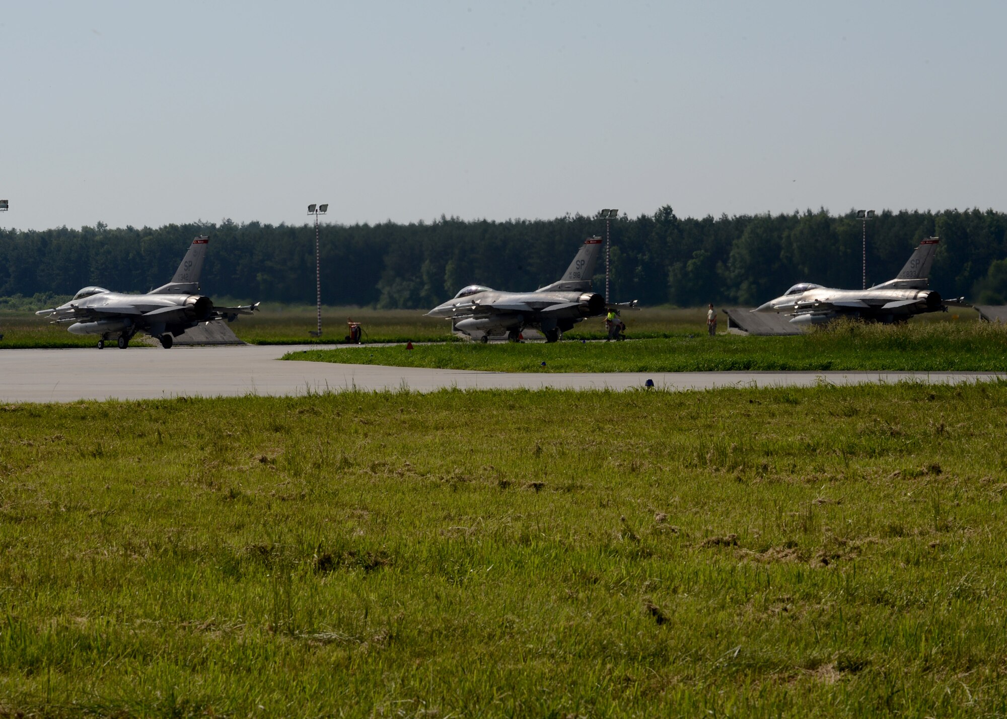 Three U.S. Air Force F-16 Fighting Falcons taxi during BALTOPS 14 at Lask Air Base, Poland, June 9, 2014. This is the first exercise to include a large amount of aircraft that will provide air-to-air and air-to-ground support. This training increases readiness for real-world operations with NATO allies and takes place from June 9-19, 2014. (U.S. Air Force photo by Airman 1st Class Kyle Gese/Released) 