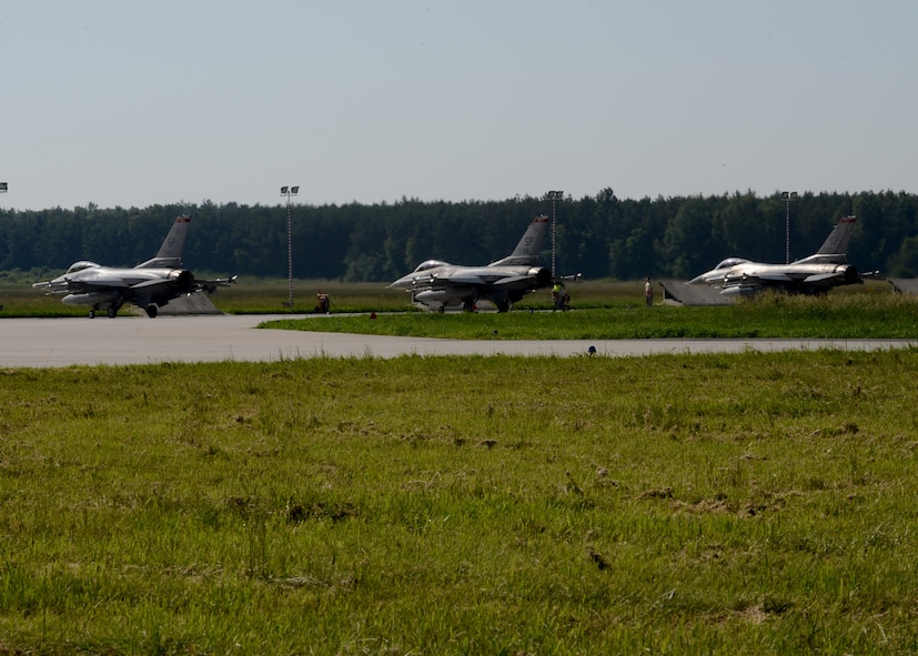 Three U.S. Air Force F-16 Fighting Falcons taxi during BALTOPS 14 at Lask Air Base, Poland, June 9, 2014. This is the first exercise to include a large amount of aircraft that will provide air-to-air and air-to-ground support. This training increases readiness for real-world operations with NATO allies and takes place from June 9-19, 2014. (U.S. Air Force photo by Airman 1st Class Kyle Gese/Released) 