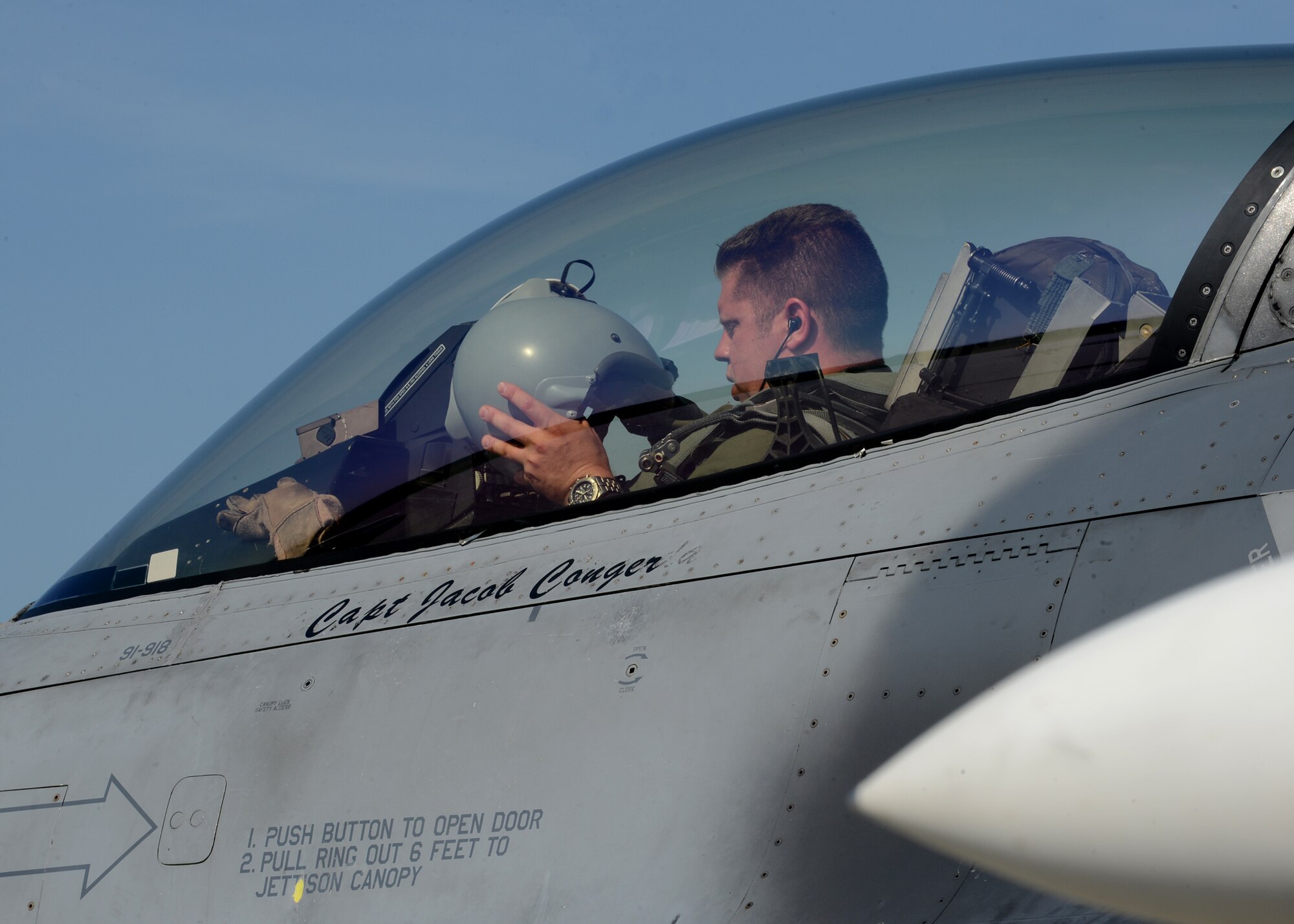 U.S. Air Force Capt. Willem Van Loon, 52nd Fighter Wing F-16 Fighting Falcon fighter aircraft pilot, puts on his helmet in preparation to fly in BALTOPS 14 at Lask Air Base, Poland, June 9, 2014. BALTOPS 14 aims to increase security in the Baltic Sea by improving interoperability and cooperation with NATO allies. It is a regional exercise appointed by the Joint Chiefs of Staff. (U.S. Air Force photo by Airman 1st Class Kyle Gese/Released)