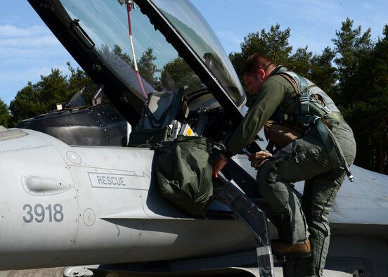 U.S. Air Force Capt. Willem Van Loon, 52nd Fighter Wing F-16 Fighting Falcon fighter aircraft pilot, steps into his jet at Lask Air Base, Poland, June 9, 2014. Van Loon flew the F-16 for BALTOPS 14, which is the largest annual multi-national maritime exercise in the Baltic Sea. There are more than 300 U.S. Airmen from the 52nd FW supporting the U.S Navy-led combined exercise, building interoperability with NATO allies. (U.S. Air Force photo by Airman 1st Class Kyle Gese/Released)