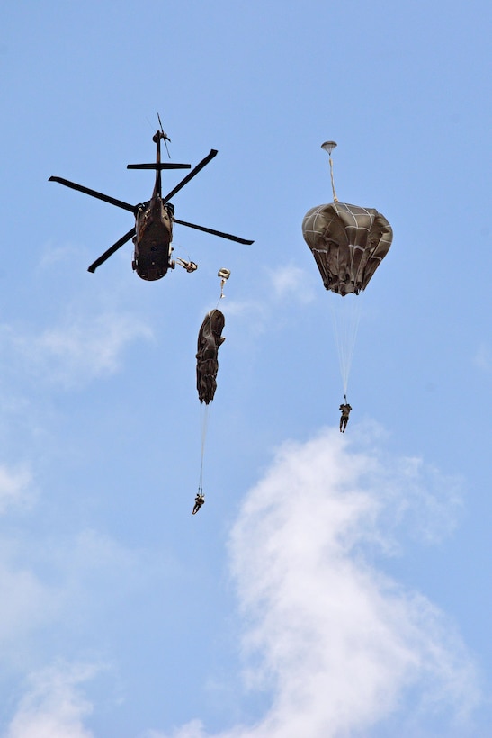 U.S. and German paratroopers jump from a UH-60 Black Hawk helicopter during a partnered airborne operation at the Joint Multinational Training Command's Grafenwoehr Training Area, Germany, June 3, 2014.