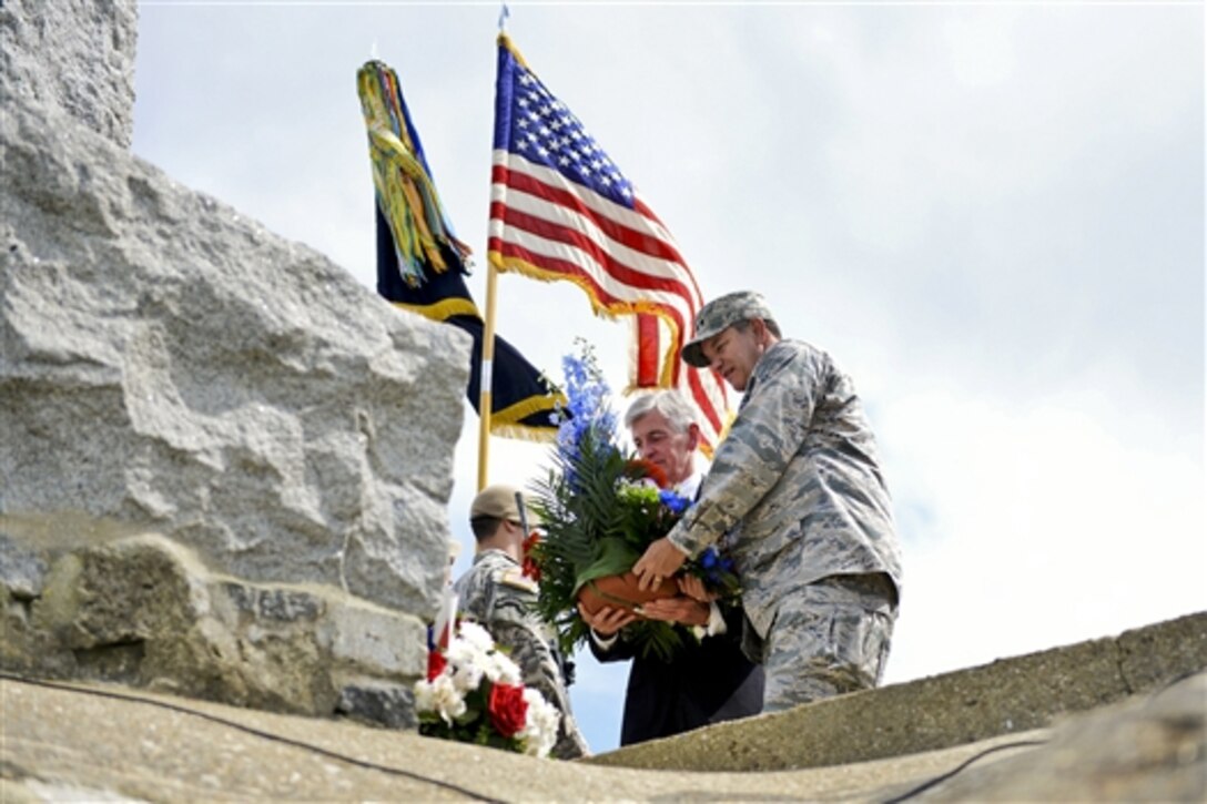 U.S. Air Force Gen. Philip M. Breedlove, right, NATO's supreme allied commander for Europe and commander of U.S. European Command, and Army Secretary John M. McHugh pay tribute to U.S. Army Rangers at a memorial ceremony in Pointe du Hoc, France, June 7, 2014. 