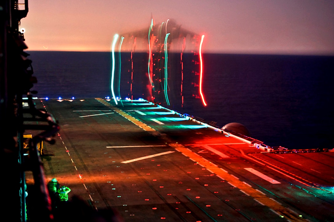 A Marine Corps Harrier AV-8 participates in night time launch and recovery operations on the flight deck of the USS Bonhomme Richard in the Pacific Ocean, Nov. 7, 2011.  
