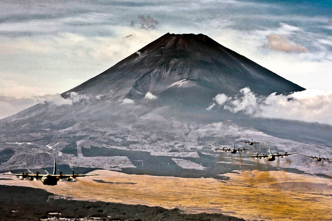 A formation of C-130 Hercules cargo aircraft fly in formation during a Samurai Surge training mission near Mount Fuji, Japan, Nov. 2, 2011. The 374th Airlift Wing uses C-130s to perform intra-theater airlift missions in the western Pacific region.  
