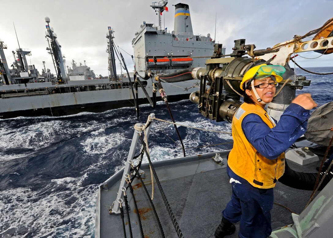 U.S. Navy Petty Officer 3rd Class Candace Worthan mans the fueling station aboard the USS Wayne E. Meyer during a replenishment with the USNS Walter S. Diehl in the Pacific Ocean, Nov. 1, 2011. Worthan is a boatswain's mate.  
