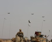AQABA, Jordan - On June 5, 2014, F-18 Hornets fly over the staged AAV Marines during  the Combined Armed Live Fire Exercise (CALFEX)  demonstration in support of Exercise Eager Lion 2014, June 5, at Jebel Petra, Jordan.  Eager Lion is a recurring, multinational exercise designed to strengthen military-to-military relationships, increase interoperability between partner nations and enhance regional security and stability.   (U.S. Marine Corps photo by; Sgt James A. Hall, CE MARFOR CENTCOM (FWD) Combat Camera/Released)