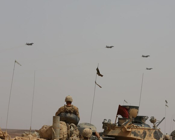 AQABA, Jordan - On June 5, 2014, F-18 Hornets fly over the staged AAV Marines during  the Combined Armed Live Fire Exercise (CALFEX)  demonstration in support of Exercise Eager Lion 2014, June 5, at Jebel Petra, Jordan.  Eager Lion is a recurring, multinational exercise designed to strengthen military-to-military relationships, increase interoperability between partner nations and enhance regional security and stability.   (U.S. Marine Corps photo by; Sgt James A. Hall, CE MARFOR CENTCOM (FWD) Combat Camera/Released)