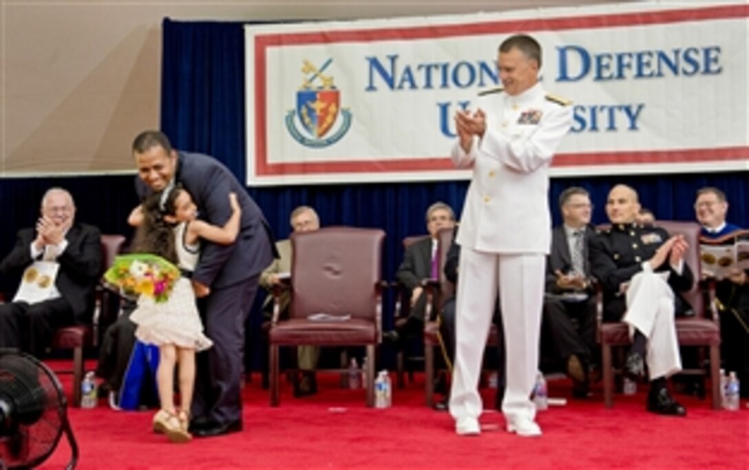 Navy Adm. James A. Winnefeld Jr., vice chairman of the Joint Chiefs of Staff, applauds after delivering the commencement address for the National Defense University's Class of 2014 on Fort McNair in Washington, D.C., June 12, 2014. The university is a national security institution focused on advanced joint education, leader development and scholarship.