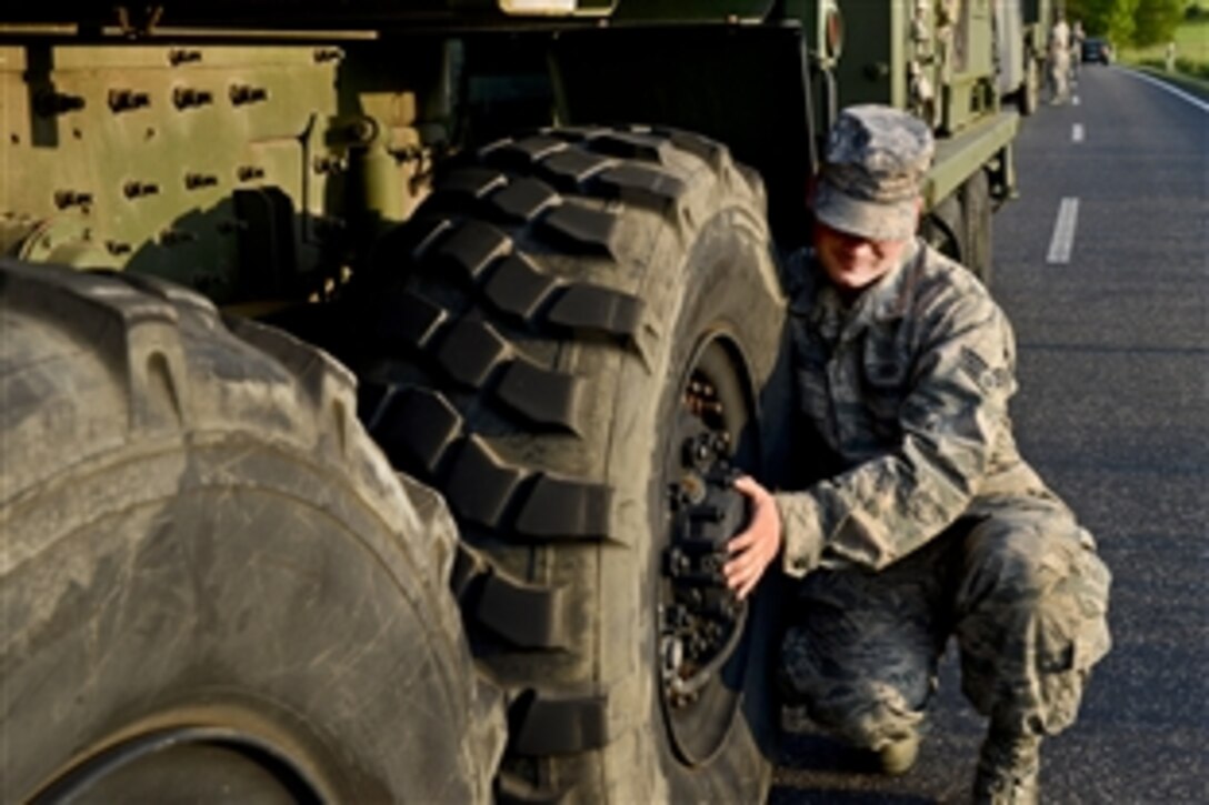 U.S. Air Force Senior Airman Robert Gordon conducts a hot brake check on his vehicle en route to Powidz Air Base, Poland, June 3, 2014. Three groups of vehicles left Spangdahlem Air Base, Germany, to convoy nearly 90 U.S. airmen to Poland to support Eagle Talon, an exercise to increase NATO interoperability.