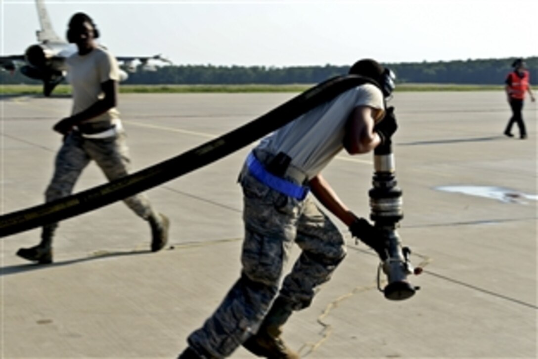 U.S. Air Force Staff Sgt. Jemarco Brooks runs a hose out to refuel a returning U.S. Air Force F-16 Fighting Falcon fighter aircraft on Lask Air Base, Poland, June 9, 2014. This is the first time U.S. forces have done hot pit refueling in Poland. U.S. forces supported Exercise Eagle Talon and Baltops14, two exerciese, by providing a rotation of 18 F-16 aircraft to train with NATO partners. Brooks is a fuels distribution operator assigned to the 52nd Logistics Readiness Squadron.