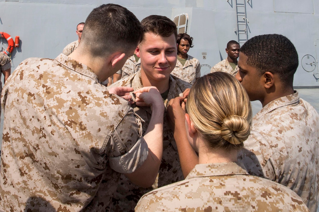 U.S. 5TH FLEET AREA OF RESPONSIBILITY (June 1, 2014) U.S. Marines with Combat Logistics Battalion (CLB) 22, 22nd Marine Expeditionary Unit (MEU), promote Cpl. Ryan Kubowicz, CLB-22 supply administrator and native of Jacksonville, Fla., to his current rank aboard the USS Mesa Verde (LPD 19). The 22nd MEU is deployed with the Bataan Amphibious Ready Group as a theater reserve and crisis response force throughout U.S. Central Command and the U.S. 5th Fleet area of responsibility. (U.S. Marine Corps photo by Cpl. Manuel A. Estrada/Released)