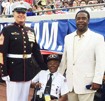 The Senior Enlisted Adviser to the Chairman of the Joint Chiefs of Staff, Marine Corps Sgt. Maj. Bryan B. Battaglia, left, alongside former World War II Army Pfc. Samuel Muldrew, 91, and Jacksonville Mayor Alvin Brown on the sidelines of EverBank Field in Jacksonville, Fla., during the USA and Nigeria teams’ soccer match, June 7, 2014.