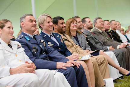 Attendees of the 2014 National Defense University graduation ceremony listen to Vice Chairman of the Joint Chiefs of Staff Admiral James A. Winnefeld, Jr. deliver his commencement address on Fort Lesley J. McNair, Washington, D.C., June 12, 2014. NDU is dedicated to being the premier national security institution focused on advanced joint education, leader development and scholarship.