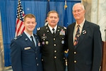 Chief Warrant Officer Dean Stoops shares a moment with his father, retired Army Lt. Col. Dick Stoops and son, Air Force Capt. Brian Stoops after a change of responsibility ceremony in Frankfort, Ky., Jan. 31, 2014. The three generations of Service members have continued a long tradition of military service in the family, Stoops said. 