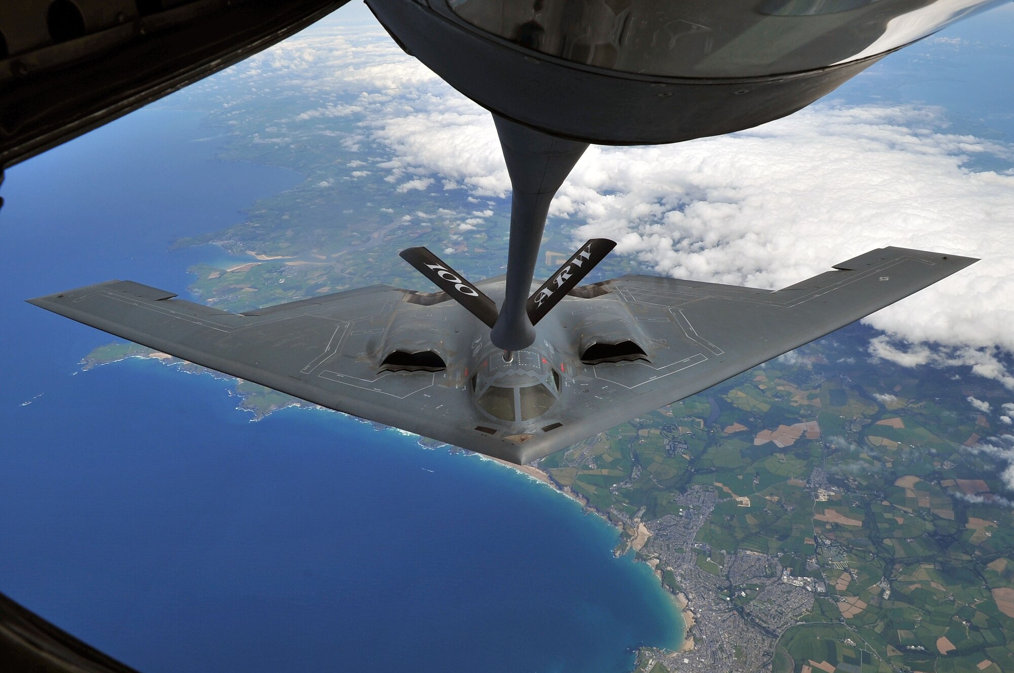 A B-2 Spirit from Whiteman Air Force Base, Mo., performed air refueling with a KC-135 Stratotanker from Royal Air Force Mildenhall June 11, 2014, over Cornwall, England. Whiteman AFB is participating in familiarization training operations while deployed to RAF Fairford. (U.S. Air Force Senior Airman/Christine Griffiths)