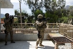 Members of the Wisconsin National Guard's 82nd Agribusiness Development Team scan an adjacent rooftop for possible threats while on a mission in Asadabad, April 8, 2012. The 82nd ADT was on a mission to meet with the Director of Agriculture Irrigation and Livestock and discuss future projects for the upcoming year.