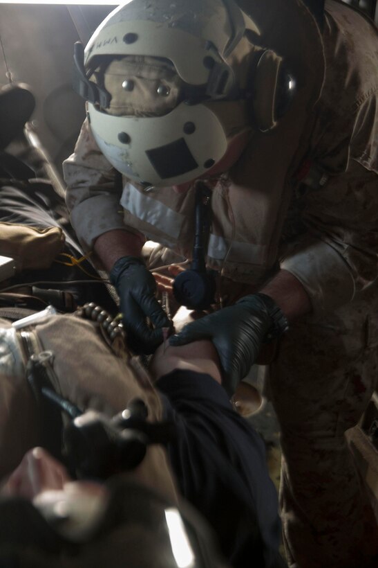 U.S. 5TH FLEET AREA OF RESPONSIBILITY (June 2, 2014) U.S. Navy Hospital Corpsman 2nd Class Patrick Doran, Combat Logistics Battalion 22, 22nd Marine Expeditionary Unit (MEU), corpsman and native of Bolingbrook, Ill., inserts an IV into a simulated casualty aboard an MV-22 Osprey tiltrotor aircraft during a tactical evacuation drill. The 22nd MEU is deployed with the Bataan Amphibious Ready Group as a theater reserve and crisis response force throughout U.S. Central Command and the U.S. 5th Fleet area of responsibility. (U.S. Marine Corps photo by Cpl. Manuel A. Estrada/Released)