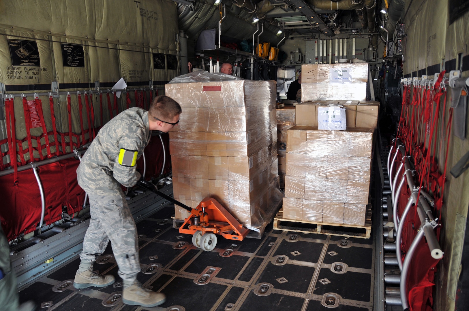 Air Force Senior Airman Jacob Lloyd, a member of the 153rd Logistics Readiness Squadron, moves simulated vaccines onto a C-130 Hercules as part of the Strategic National Stockpile exercise in Wyoming, May 14, 2012. Airmen assigned to the Wyoming Air National Guard worked with multiple state agencies to test state health officials' abilities to receive, deliver and distribute medical supplies to various parts of the state.
