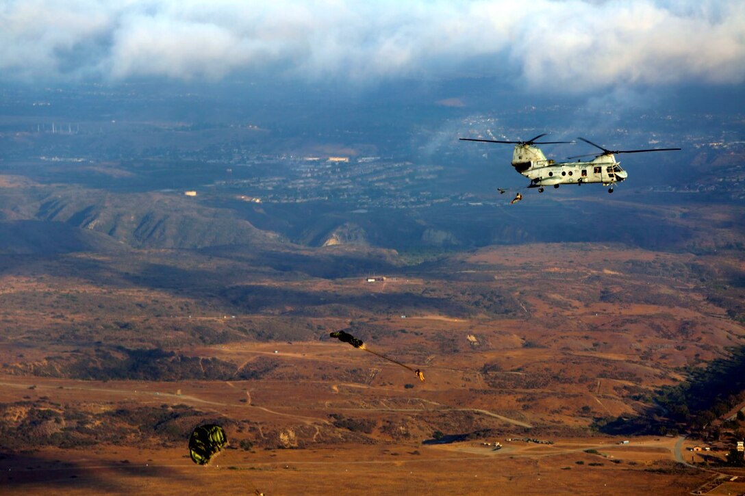 Marines with 1st Air Delivery platoon conducted static line jumping out of a CH-46 Sea Knight aboard Camp Pendleton, Calif., June 5, 2014. The Marines conducted two day jumps and two night jumps at around 1,500 feet.  Three Marines jumped with full combat gear in order to complete the requirements for their gold wings.