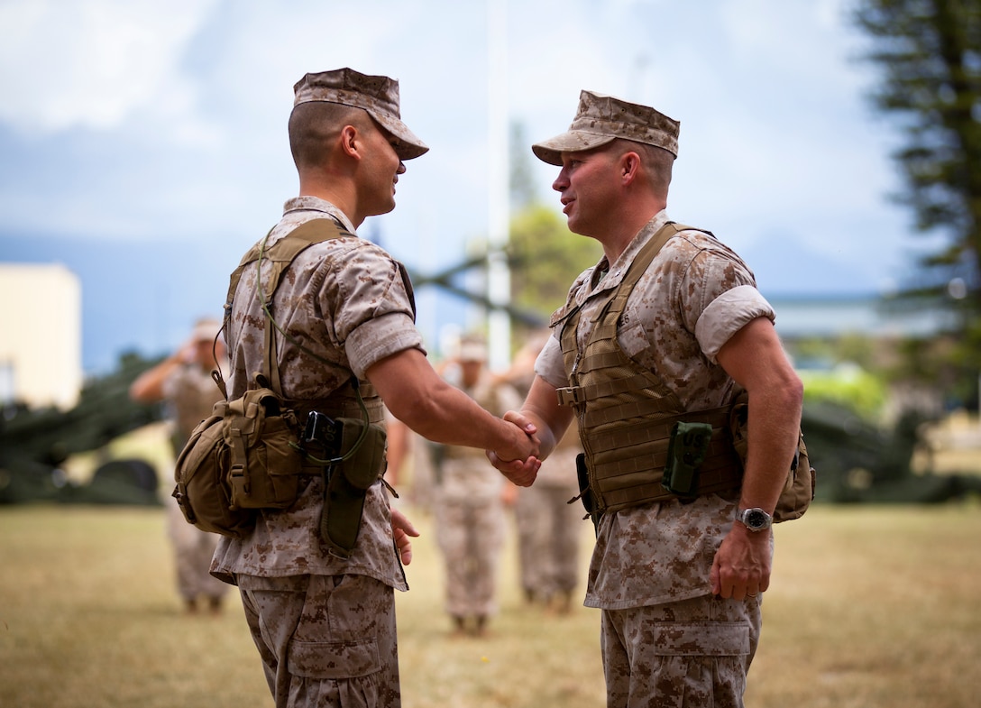 MARINE CORPS BASE HAWAII - Lt. Col. Daniel J. Skuce (left), 1st Battalion, 12th Marine Regiment commanding officer, and Lt. Col. Michael J. Roach (right), greet each other during the 1st Bn., 12th Marines change of command ceremony at Dewey Square aboard Marine Corps Base Hawaii, June 11, 2014. During the ceremony Roach relinquished command of 1st Bn., 12th Marines to Skuce. (U.S. Marine Corps photo by Lance Cpl. Aaron Patterson)