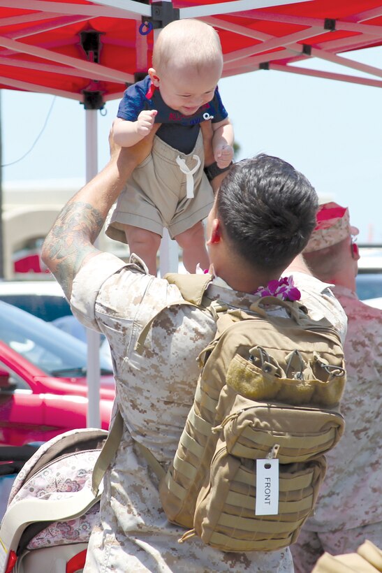 Cpl. Anthony Hunter, a rifleman with Golf Company, 2nd Battalion, 3rd Marine Regiment, welcomes his son upon returning to Marine Corps Base Hawaii, June 12, 2014, from a six-month unit deployment program in Japan. The “Island Warriors” arrived over the course of three days to compensate for the large size of the unit. The battalion conducted three significant training missions in Japan and Korea. Its main mission was to participate in bilateral training with Republic of Korea Marines to improve interoperability between the two countries. (U.S. Marine Corps photo by Cpl. Janelle Y. Villa)