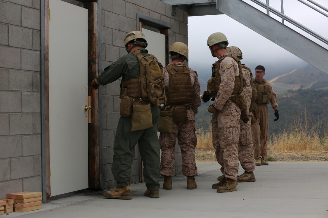 A Marine from 1st Reconnaissance Battalion prepares to place explosive charges during a Methods of Entry proficiency training exercise aboard Camp Pendleton Calif., June 10.  During the exercise, raid scenarios were tailored for the event to keep the Marines in an operational mindset while honing their skill set for future deployments as the Maritime Raid Force in support of Marine Expeditionary Units. 
