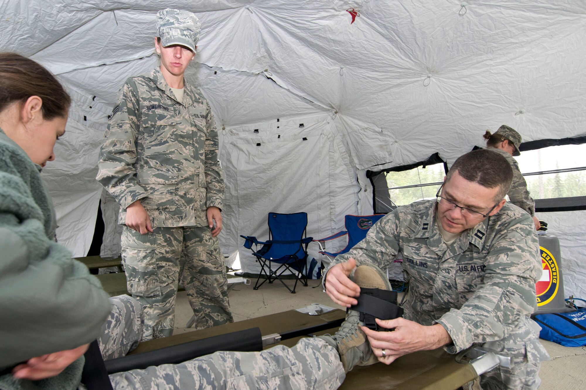 JOINT BASE ELMENDORF-RICHARDSON, Alaska-- Capt. Jason Collins and other 176 Medical Group members practice medical aid techniques during an exercise here at Camp Mad Bull here June 9, 2014. The 176 Mission Support Group and the 176 Medical Group participated as part of Polar Guardian 14-2. (U.S. Air National Guard photo by Capt. John Callahan/ Released)