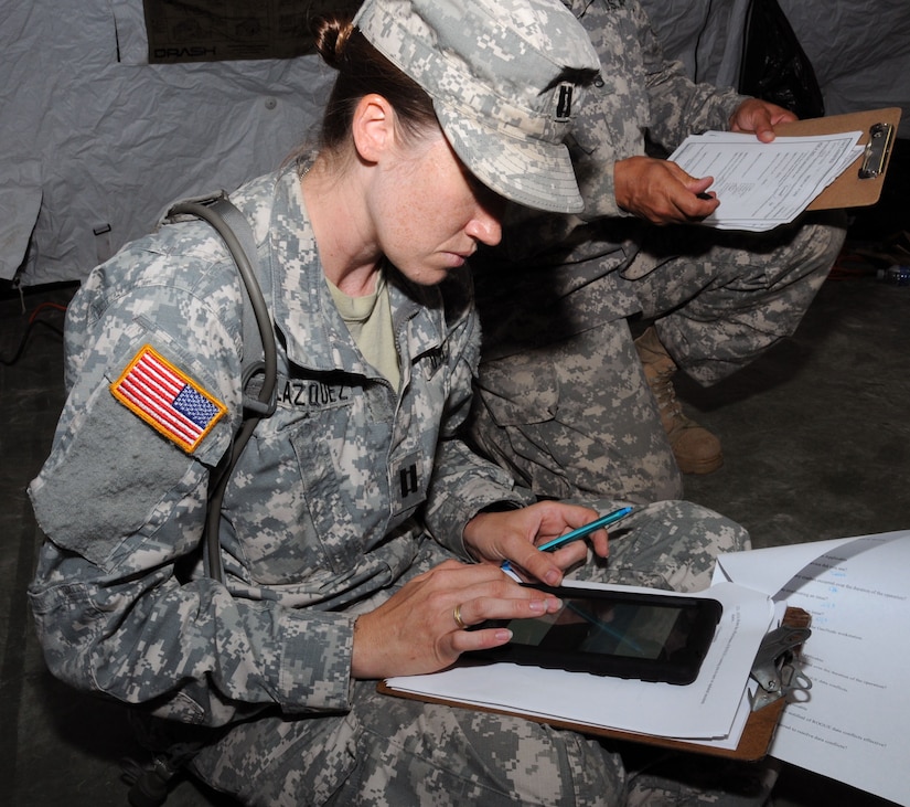 U. S. Army Capt. Erin Velazquez studies a route recon on a tablet using the GeoSHAPE program.  In preparation for the 2014 hurricane season, the Joint Task Force-Bravo Medical Element (MEDEL) conducted a humanitarian assistance/disaster response (HA/DR) exercise at Soto Cano Air Base, Honduras June 12, 2014.  The MEDEL's mission was to establish a forward medical treatment operation capable of providing triage, primary care, surgical capabilities, patient holding and evacuation.  As part of this exercise, a suite of mobile technology applications that run on smartphones and tablets were used to enhance the capabilities of the unit: Global MedAid, Medical Application of Speech Translation (MAST) and GeoSHAPE.  (Photo by U. S. Air National Guard Capt. Steven Stubbs)