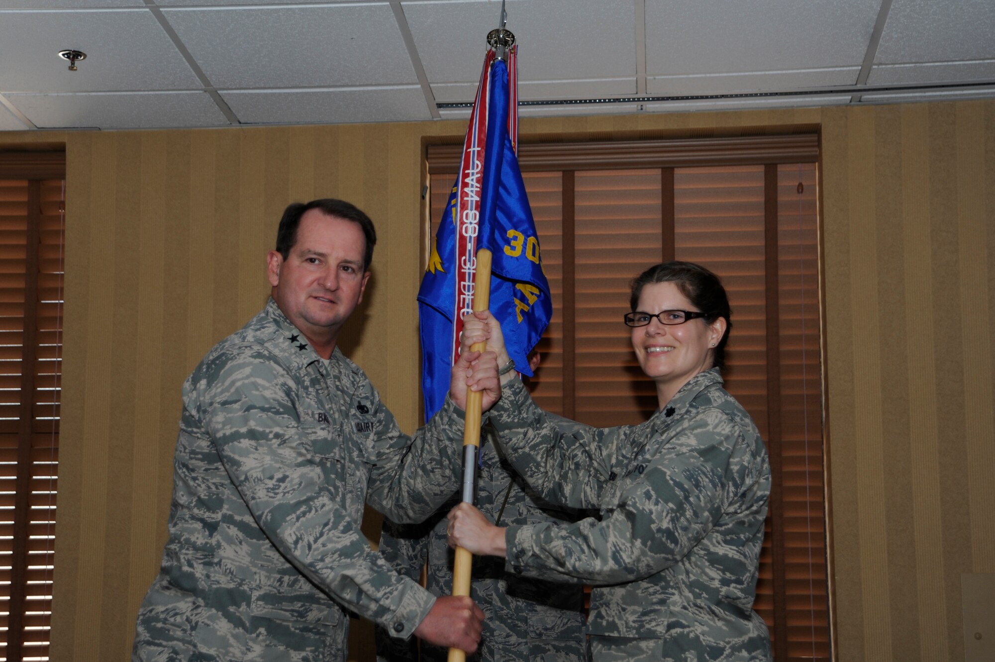 U.S. Air Force Maj. Gen. Brent Baker, Ogden Air Logistics Complex commander,
passes the guidon to Lt. Col. Margaret Romero, as she assumes command of the
309th Aerospace Maintenance and Regeneration Group at Davis-Monthan Air
Force Base, Ariz., June 13, 2014. AMARG, also known as the Boneyard, is a
tenant unit at D-M, but falls under the Ogden Air Logistics Complex at Hill
AFB, Utah.  (U.S. Air Force photo by Airman 1st Class Betty R.
Chevalier/Released)