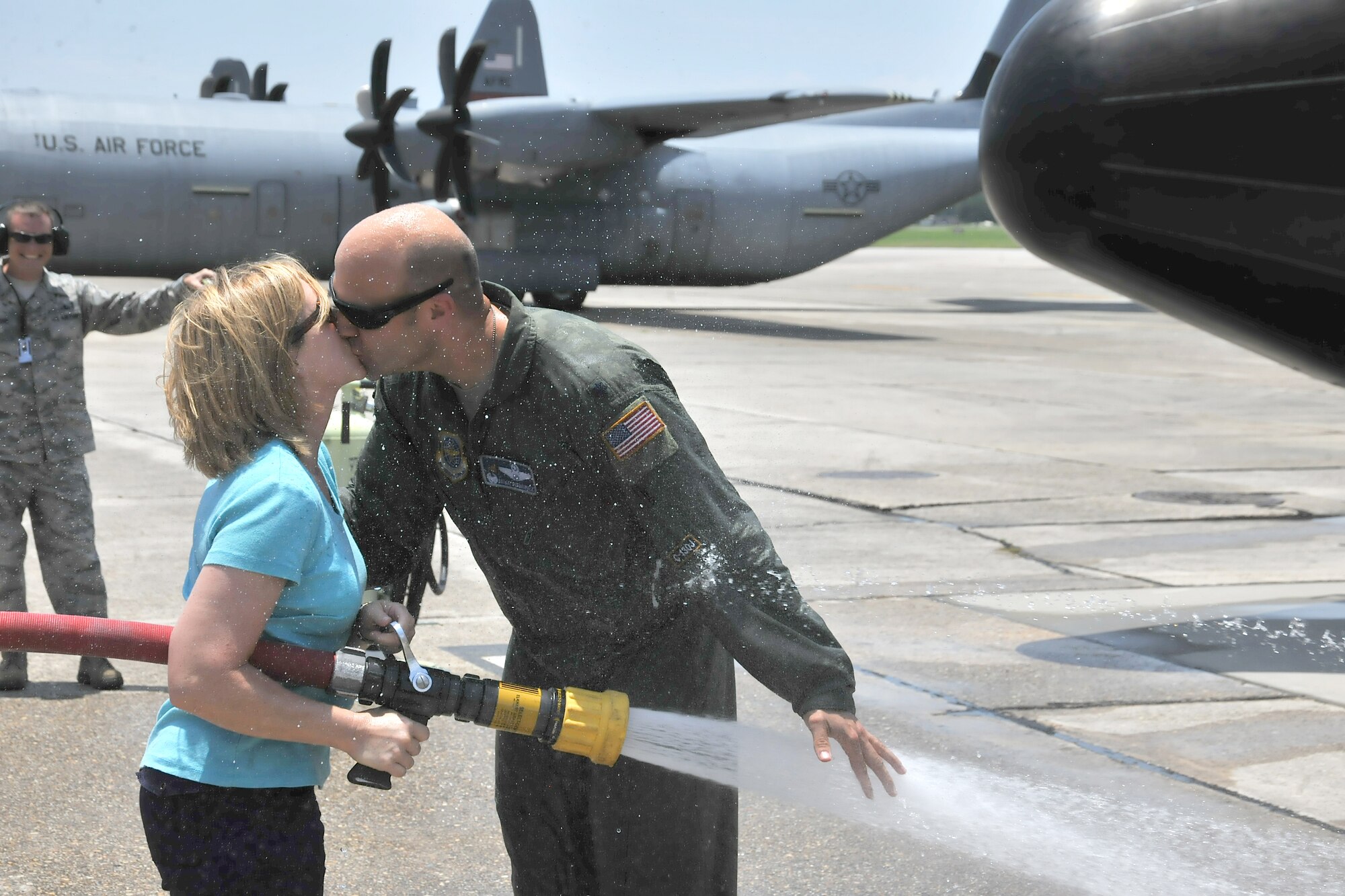 Lt. Col. Michael Ramirez, the 345th Airlift Squadron Commander shares a celebatory kiss with his wife, Becky Ramirez immediately after his "fini flight" of a C-130J at Keesler Air Force Base in Biloxi Mississippi 12 June.
