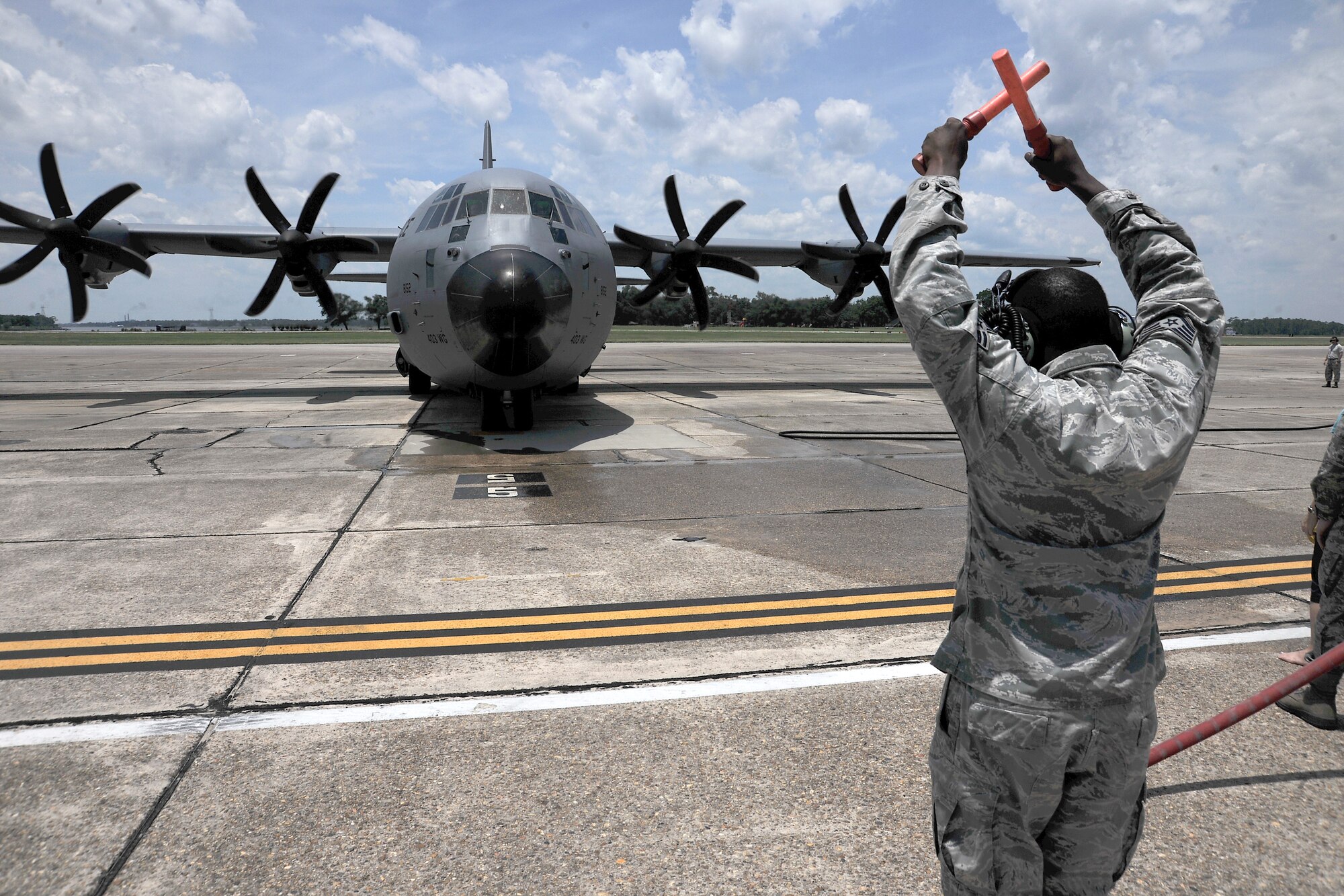 Lt. Col. Michael Ramirez, the 345th Airlift Squadron commander at Keesler Air Force Base in Biloxi Mississippi brings his C-130J aircraft to a halt during his "fini flight" 12 June. Ramirez celebrated with 403rd Wing members and family.