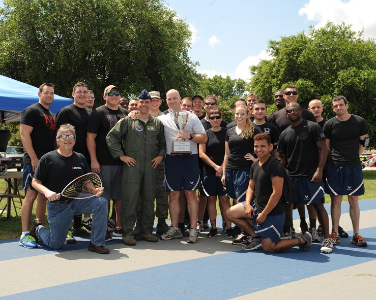 Airmen from the 26th Operational Weather Squadron pose with the 1st place trophy during Sports Day at Barksdale Air Force Base, La., June 13, 2014. The 26th OWS defeated the champions from 2013, the 2nd Maintenance Squadron, and own bragging rights until next year’s Sports Day. (U.S. Air Force photo/Senior Airman Benjamin Gonsier)
