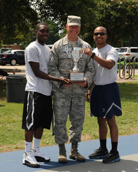 Airmen from the 2nd Maintenance Squadron pose with the 2nd place trophy during Sports Day at Barksdale Air Force Base, La., June 13, 2014. Only one point separated the 3rd place team, 2nd Medical Group, and 2nd place team, 2nd MXS. (U.S. Air Force photo/Senior Airman Benjamin Gonsier)