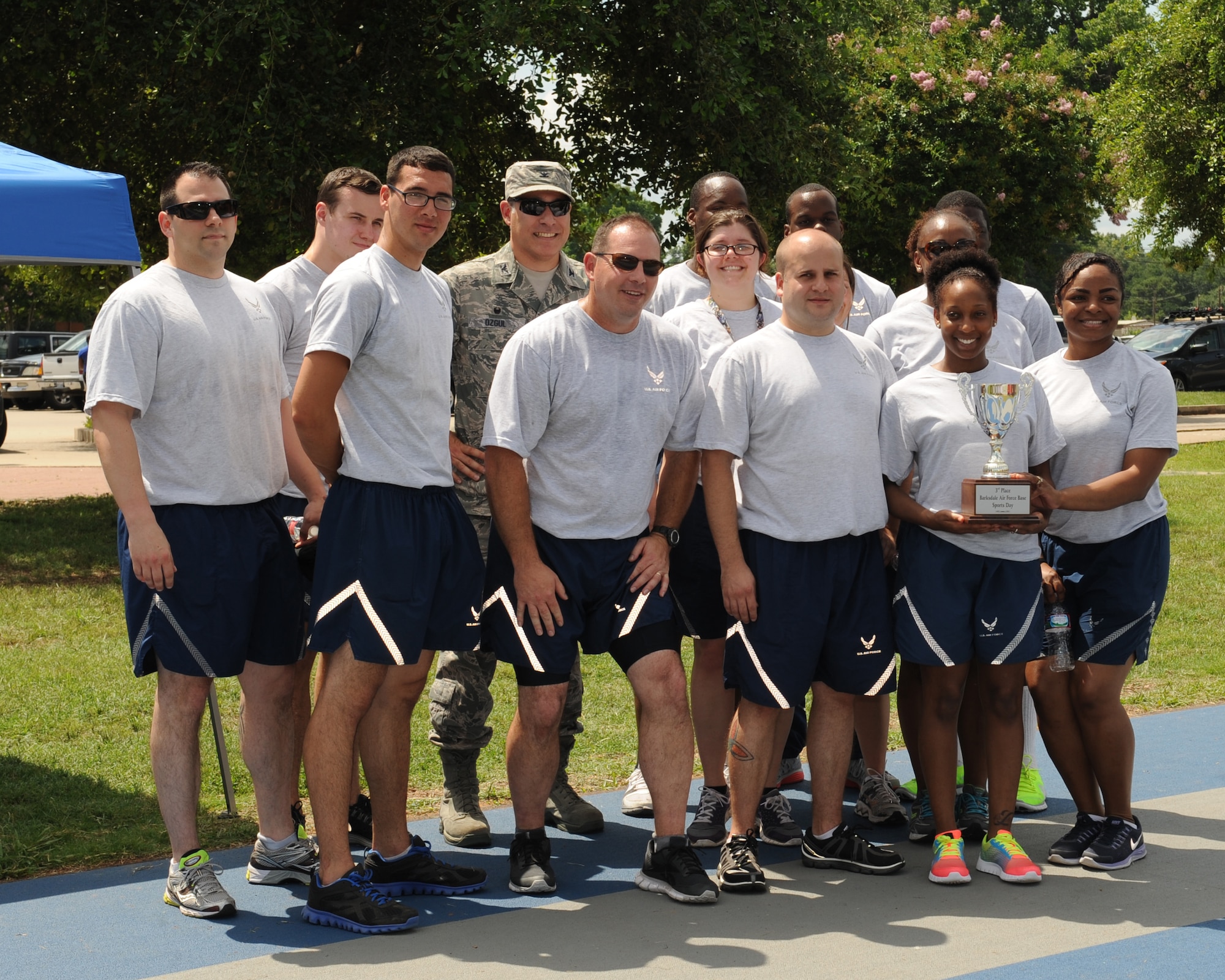 Airmen from the 2nd Medical Group pose with the 3rd place trophy during Sports Day at Barksdale Air Force Base, La., June 13, 2014. Sports Day was designed to improve teamwork and help increase the awareness of fitness, sports programs and boost morale. (U.S. Air Force photo/Senior Airman Benjamin Gonsier)
