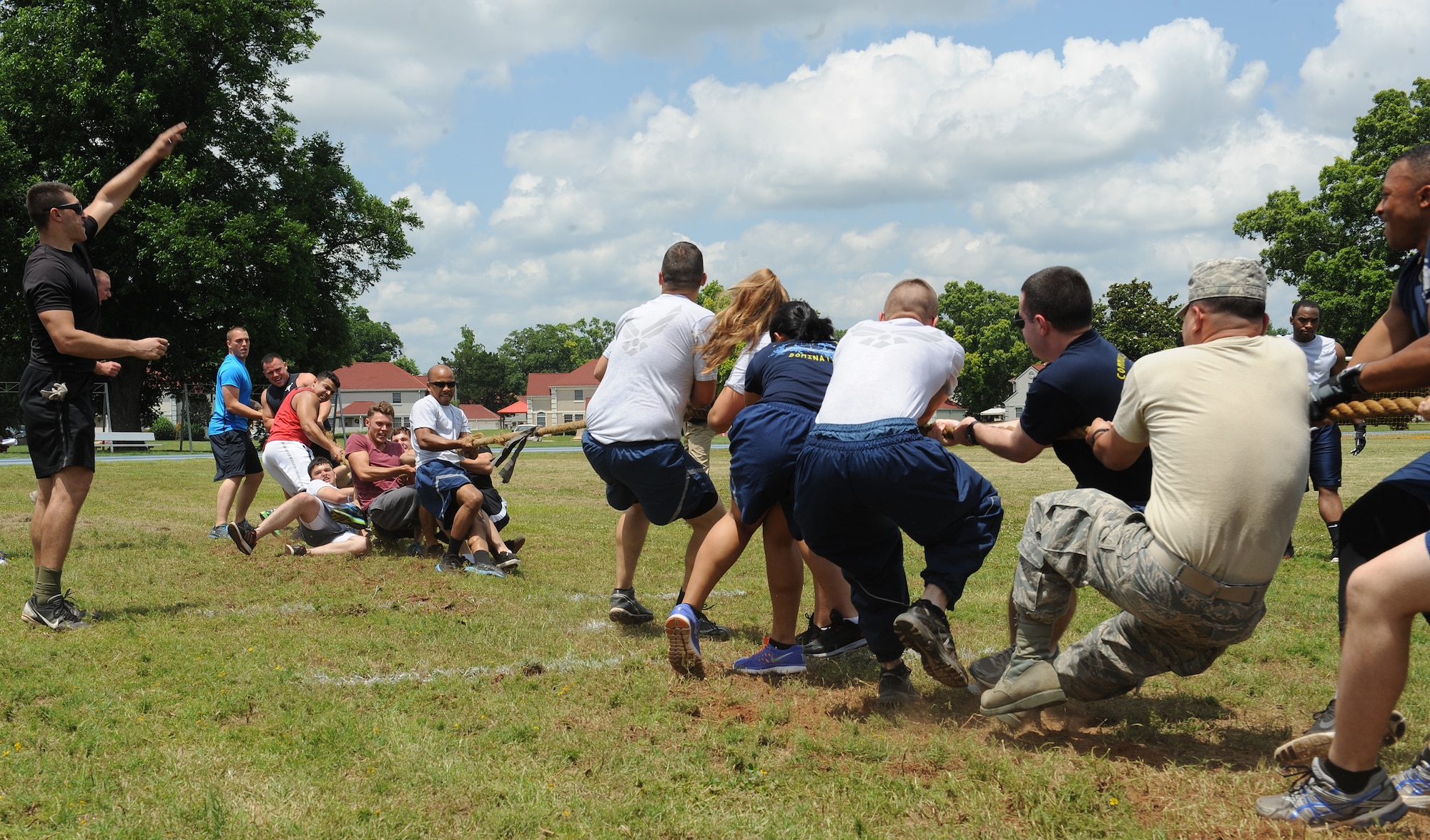 Airmen from the 2nd Maintenance Squadron, left, and 2nd Communications Squadron, right, compete in a tug-of-war match as part of Sports Day at Barksdale Air Force Base, La., June 13, 2014. Sports Day is comprised of various competitive athletic events to help promote physical fitness. (U.S. Air Force photo/Senior Airman Benjamin Gonsier)