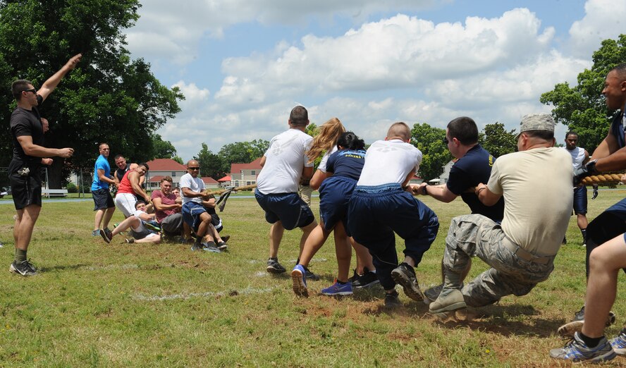 Airmen from the 2nd Maintenance Squadron, left, and 2nd Communications Squadron, right, compete in a tug-of-war match as part of Sports Day at Barksdale Air Force Base, La., June 13, 2014. Sports Day is comprised of various competitive athletic events to help promote physical fitness. (U.S. Air Force photo/Senior Airman Benjamin Gonsier)