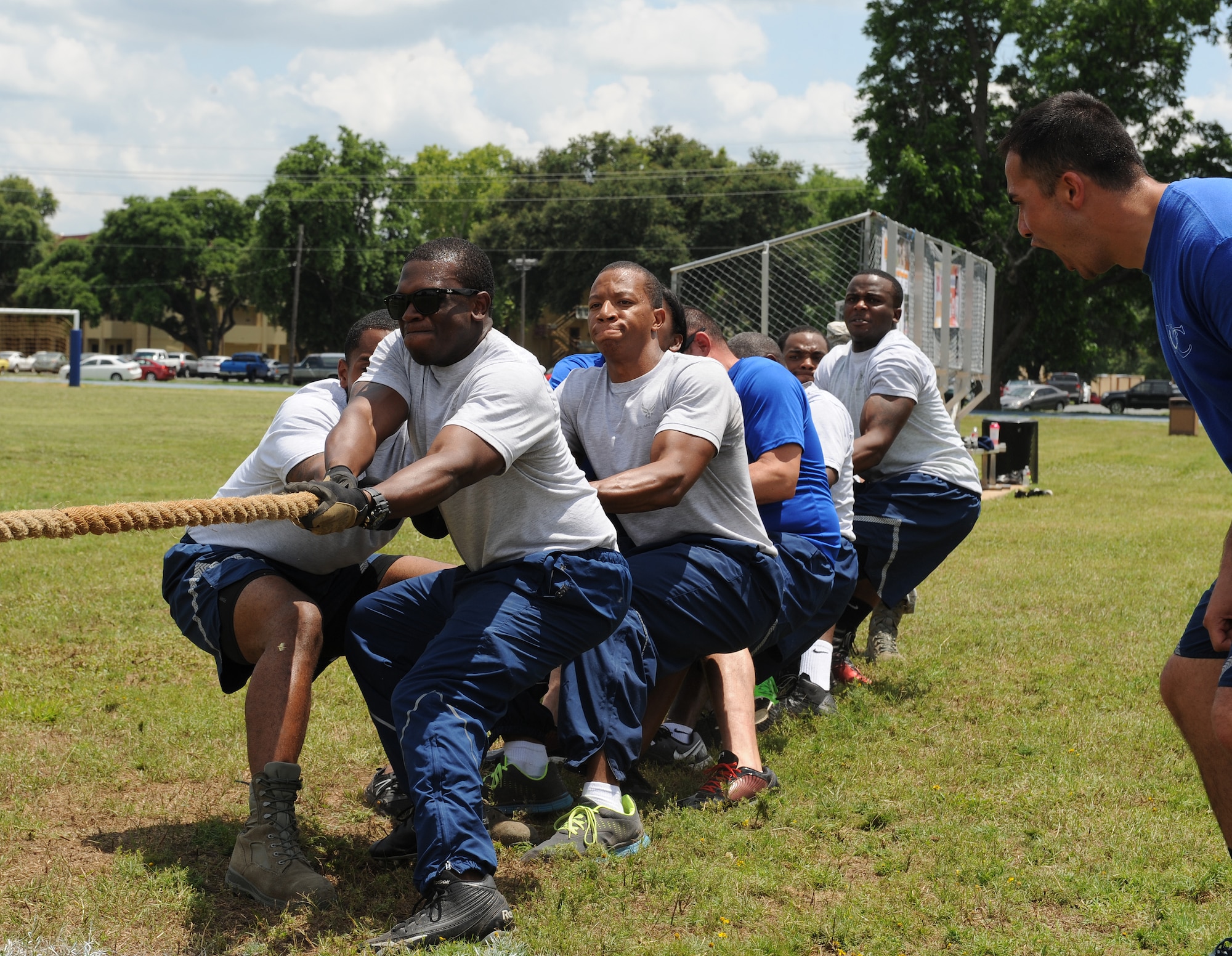 Airmen from the 2nd Civil Engineer Squadron pull a rope during a tug-of-war competition as part of Sports Day at Barksdale Air Force Base, La., June 13, 2014. Sports Day consisted of various team events including dodgeball, tug-of-war, soccer, volleyball, basketball and a homerun derby. (U.S. Air Force photo/Senior Airman Benjamin Gonsier)