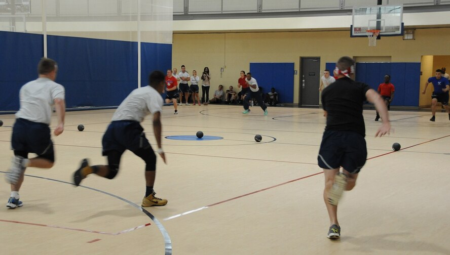 Barksdale Airmen sprint to a row of balls during a dodgeball competition as part of Sports Day at Barksdale Air Force Base, La., June 13, 2014. Sports Day is an annual event that gives Airmen the opportunity to participate in several individual and team sports to boost morale and camaraderie. (U.S. Air Force photo/Senior Airman Benjamin Gonsier)