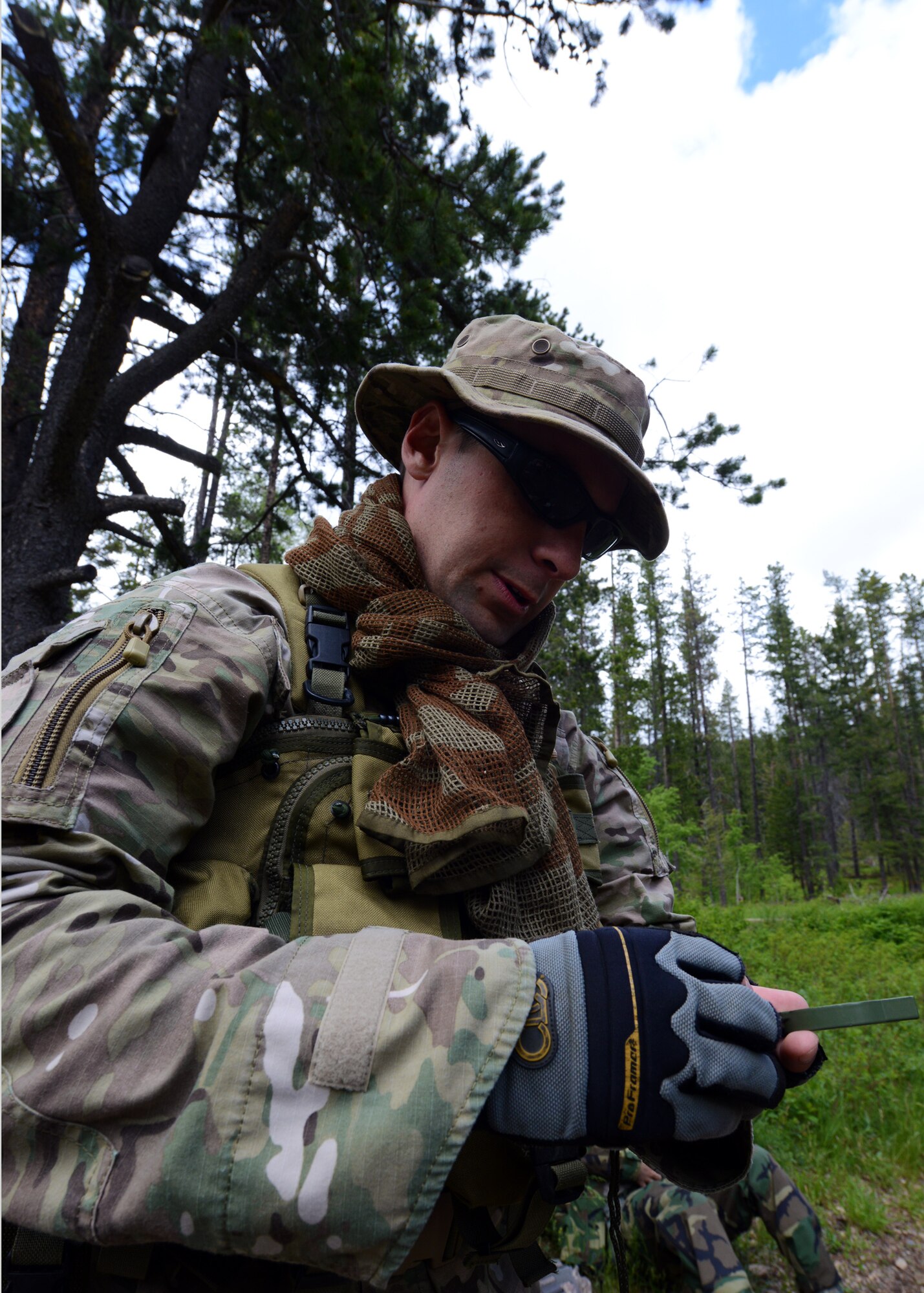 Staff Sgt. John Patnaude, 341st Security Forces Group Tactical Response Force Nuclear Advanced Designated Marksman, uses a lensatic compass for land navigation during a field training exercise in Monarch, Mont. June 11. Patnaude and two other NATMs received survival training from a SERE specialist. (U.S. Air Force photo/Senior Airman Katrina Heikkinen)